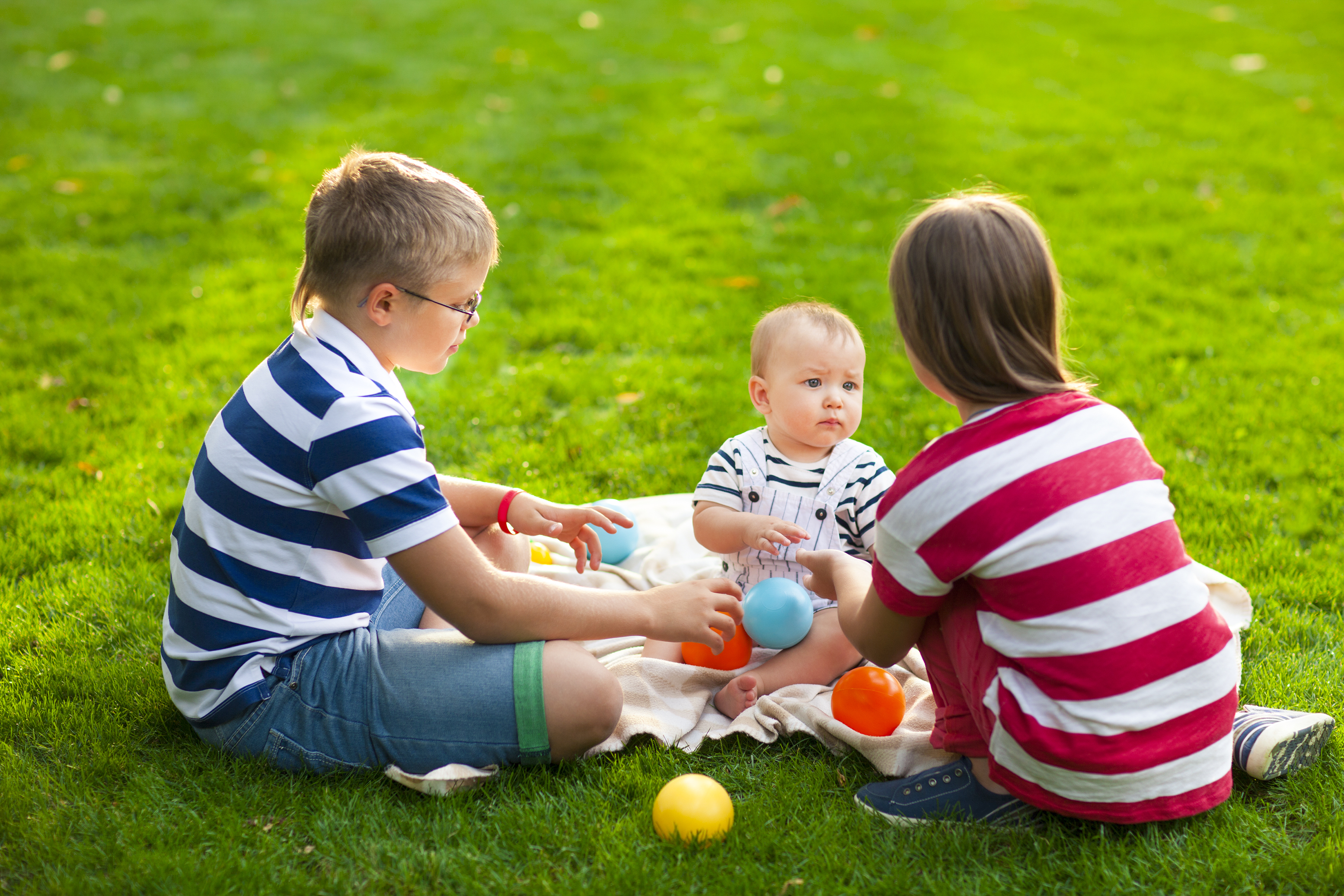 toddlers and infants playing outside together