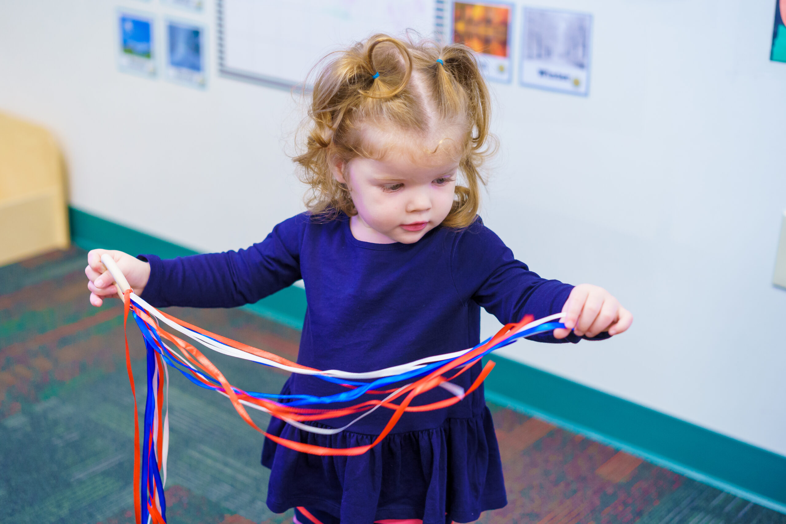 Young toddler playing with ribbons